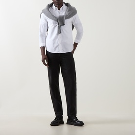 Model wearing Belstaff white cotton casual shirt with grey scarf draped over shoulders, styled with black tapered trousers and black leather shoes