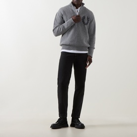 Model wearing grey quarter-zip sweatshirt, styled with white T-shirt, black slim trousers and black shoes