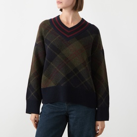 Model wearing Barbour Shadow Classic Tartan wool V-neck jumper with contrast navy ribbed trim, styled with blue jeans.