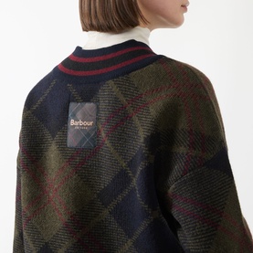 Model wearing Barbour Shadow Classic Tartan wool knitwear, argyle pattern with navy rib collar, red stripe trim and Barbour label detail.