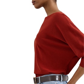 Model wearing Phase Eight brown short-sleeve top, styled with light-wash jeans and a silver belt