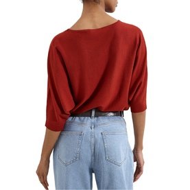 Model wearing Phase Eight brown knit top with bateau neckline, three-quarter sleeves, styled with light blue jeans, seen from behind.