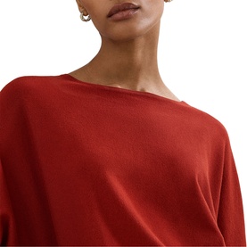 Model wearing Phase Eight brown knit top with batwing-style drape neckline, styled with small gold hoop earrings.