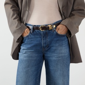 Model wearing FRAME DENIM Wide Leg Jeans in Lucky Raw After, styled with a brown belt with gold buckle and grey blazer.