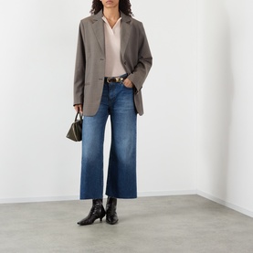 Model wearing FRAME DENIM Wide Leg Jeans in Lucky Raw After, styled with a grey blazer, blush shirt and black ankle boots.