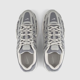 Nike grey and white chunky sole trainers, overhead view showing mesh and suede upper with silver tonal lacing detail