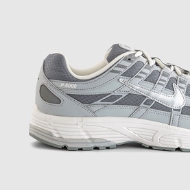 Nike P-6000 trainer in grey and white, featuring silver Swoosh logo, mesh upper, and chunky white sole