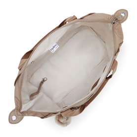 Kipling bag interior in beige, showing cream fabric lining, zip pocket, and top zip closure with metal hardware.