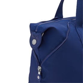 Cobalt blue nylon tote bag close-up showing zip closure, exterior pocket, and silver-tone hardware detail.