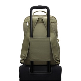 Kipling Almost Sage green nylon backpack shown mounted on luggage trolley handle, rear pass-through sleeve visible