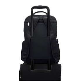 Black backpack with luggage pass-through sleeve mounted on a wheeled suitcase handle, rear view showing padded back panel and top carry handle