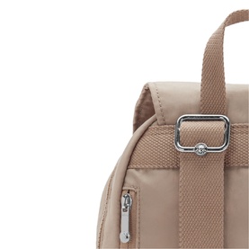 Close-up of beige nylon backpack showing silver hardware adjuster, top handle, and zip detail