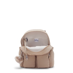 Kipling beige nylon backpack, open top view showing cream interior, multiple front pockets and signature monkey keychain
