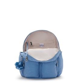 Kipling Vintage Blue backpack, open to show cream interior lining, front zip pockets and signature blue monkey keychain.