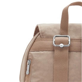 Close-up of a beige nylon backpack showing silver adjustable buckle, padded top handle, and zip pocket detail.