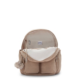 Kipling beige backpack shown open, revealing spacious interior with pale lining, front pockets, and signature monkey keyring charm.