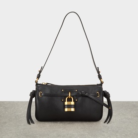 Chlo&eacute; black lambskin shoulder bag with gold padlock hardware, knotted tassel trim, and single adjustable strap