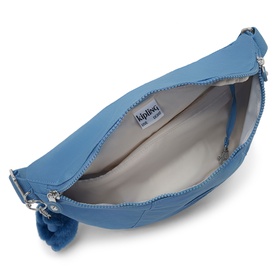 Kipling Vintage Blue crossbody bag, open zip showing grey interior lining and silver-tone hardware, with monkey keyring charm.