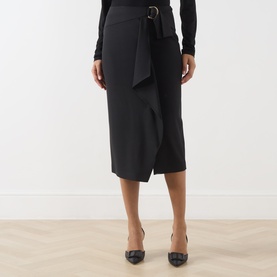 Model wearing Max Mara Studio nero wool wrap midi skirt with self-tie belt, styled with black heels.
