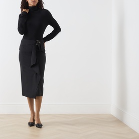 Model wearing Max Mara Studio Nero wool pencil skirt with belt tie detail, styled with black roll-neck and flat shoes.