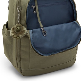 Kipling khaki green backpack open to reveal blue interior lining, with signature monkey keychain and silver-tone zip hardware
