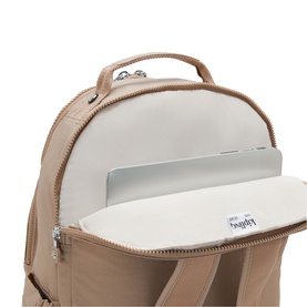 Kipling backpack in tan, open to reveal padded laptop compartment with silver hardware detail visible
