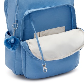 Kipling Vintage Blue backpack, open main compartment showing cream lining, silver zip detail and signature monkey keyring charm.