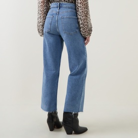 Model wearing AgoldE Wide Leg jeans in Measure blue denim, cropped raw hem, paired with black western ankle boots and leopard print blouse