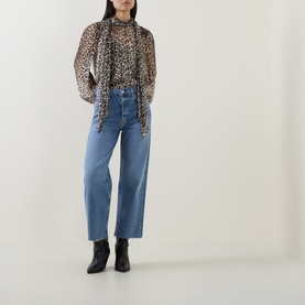 Model wearing AgoldE Wide Leg Jeans in Measure blue denim, styled with leopard print blouse and black ankle boots.