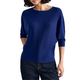 Model wearing Phase Eight blue elbow-sleeve knit top with boat neckline, styled with dark denim jeans.