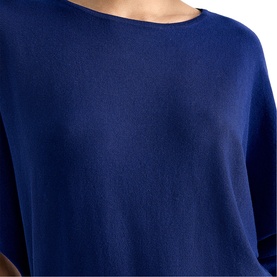 Model wearing Phase Eight blue fine knit top with relaxed fit and round neckline, cropped view showing short sleeves