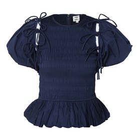 Damson Madder navy cotton blouse with smocked body, puff sleeves, tie bow details, and peplum hem