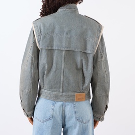 Model wearing Isabel Marant Etoile denim jacket in multi, rear view, oversized collar detail, leather logo patch, styled with light blue jeans