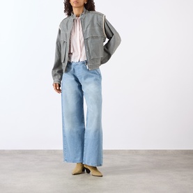 Model wearing Isabel Marant Etoile multi grey cotton jacket, styled with light blue wide-leg jeans, pink blouse, and beige mules.