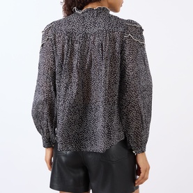 Model wearing Isabel Marant Etoile black and ecru cotton top with ruffle collar, pintuck yoke, puff sleeves and button front, styled with black