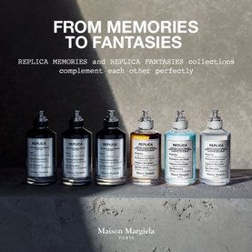 Maison Margiela Replica fragrance collection display featuring six eau de toilette bottles in silver and frosted glass on a concrete shelf.