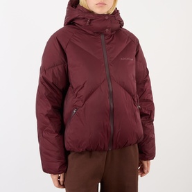 Model wearing Adanola Logo Diamond Quilted Jacket in Damson Red, featuring hood, diamond quilting and concealed zip, styled with brown trousers.