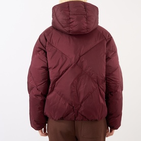 Model wearing Adanola Logo Diamond Quilted Jacket in Damson Red, showing rear view with hood and diagonal quilted panels, styled with brown trousers