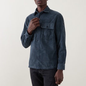 Model wearing Belstaff casual shirt in petrol blue, chest flap pocket, styled with dark grey jeans