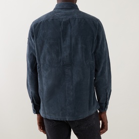 Model wearing Belstaff petrol casual shirt, rear view showing relaxed fit, cord texture, and back seam detail, styled with dark jeans