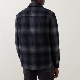 Model wearing Belstaff black plaid cotton casual shirt, rear view, styled with dark denim jeans