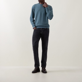Model wearing Belstaff petrol cotton sweatshirt with crew neck, styled with dark grey jeans and brown leather shoes.