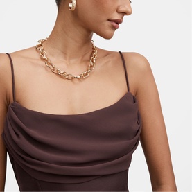 Model with Forever New chunky gold-tone chain-link necklace, styled with chocolate cowl-neck spaghetti-strap dress and pearl earrings