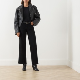Model wearing FRAME DENIM Black Wide Leg Jeans, styled with a black leather biker jacket and black ankle boots.