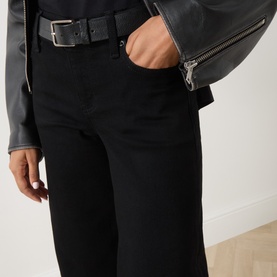 Model wearing FRAME DENIM black wide leg jeans with a black leather belt, styled with a grey leather jacket.