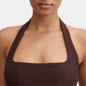 Model wearing Forever New chocolate halterneck top, close-up showing square neckline and tie neck detail