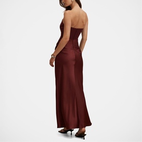 Model wearing Forever New Vintage Burgundy satin strapless maxi dress with corseted bodice, styled with black heels.