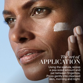 Model with La Mer Moisturizing Soft Cream applied to cheek, demonstrating pea-sized application technique on cleansed skin.