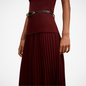 Model wearing Forever New Burgundy Rose pleated midi dress with peplum waist detail, styled with a black leather belt with gold buckle