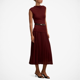Model wearing Forever New Burgundy Rose sleeveless midi dress with pleated skirt, styled with black belt and black heels
